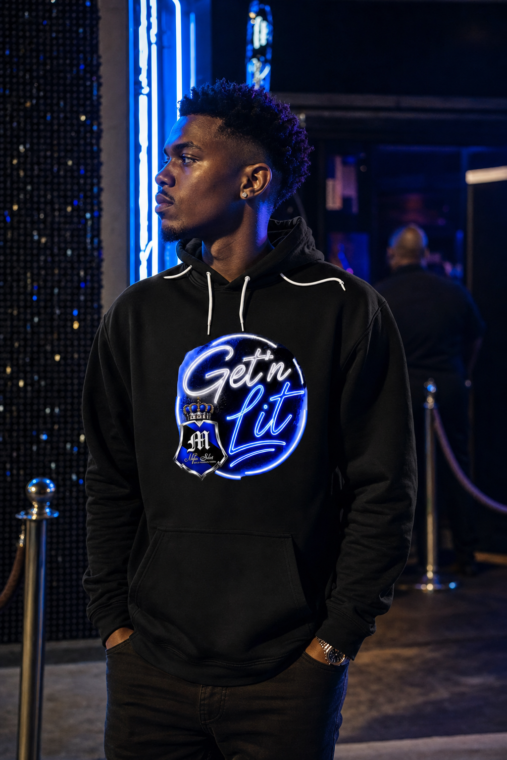 MSV Get N' Lit hoodie lifestyle — model at neon-lit nightclub entrance